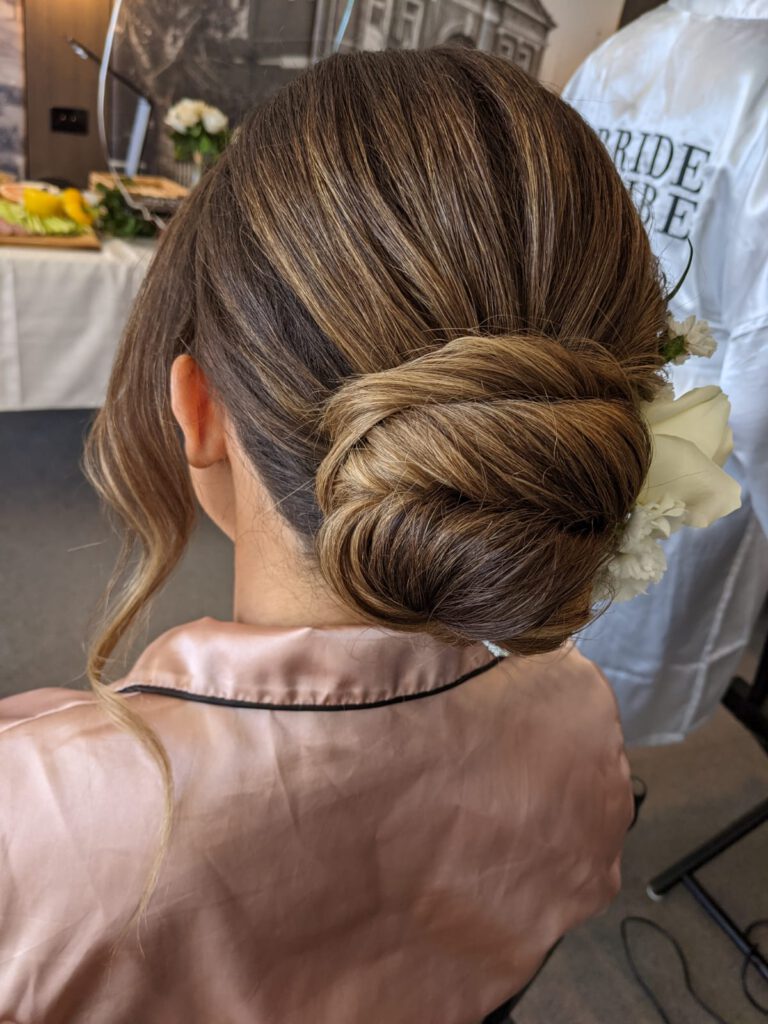 rear view of a woman with her bridal hair and makeup done on her wedding